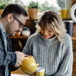 Happy young couple managing finances savings and enjoyment