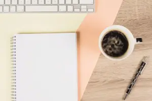 focused work desk with coffee and notebook