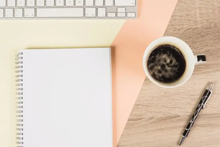 focused work desk with coffee and notebook